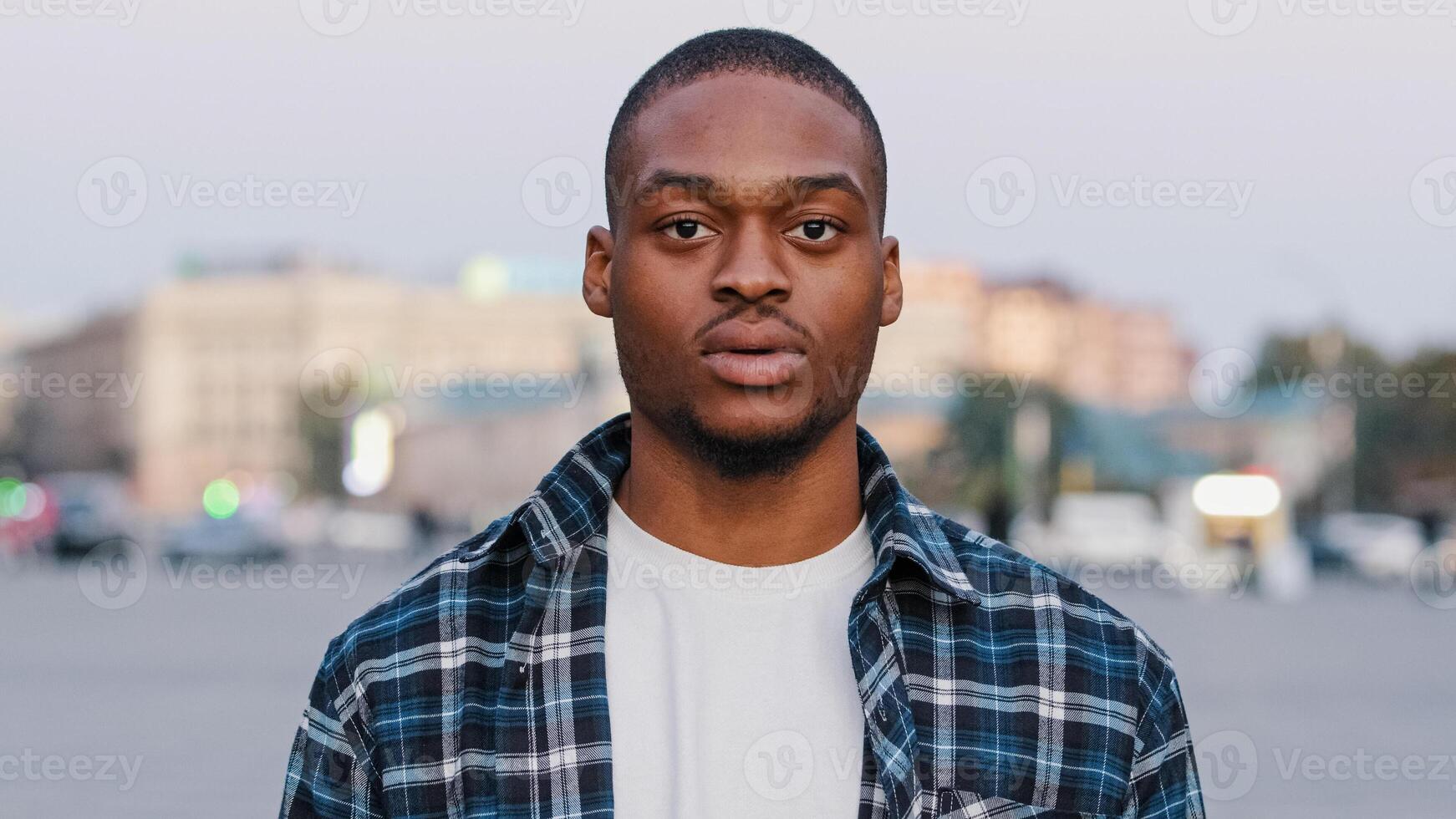 Male portrait in city african american guy handsome young adult man looking at camera disappointed face feeling sad displeasure upset loses losing doing lost gesture hands talking problem concept photo