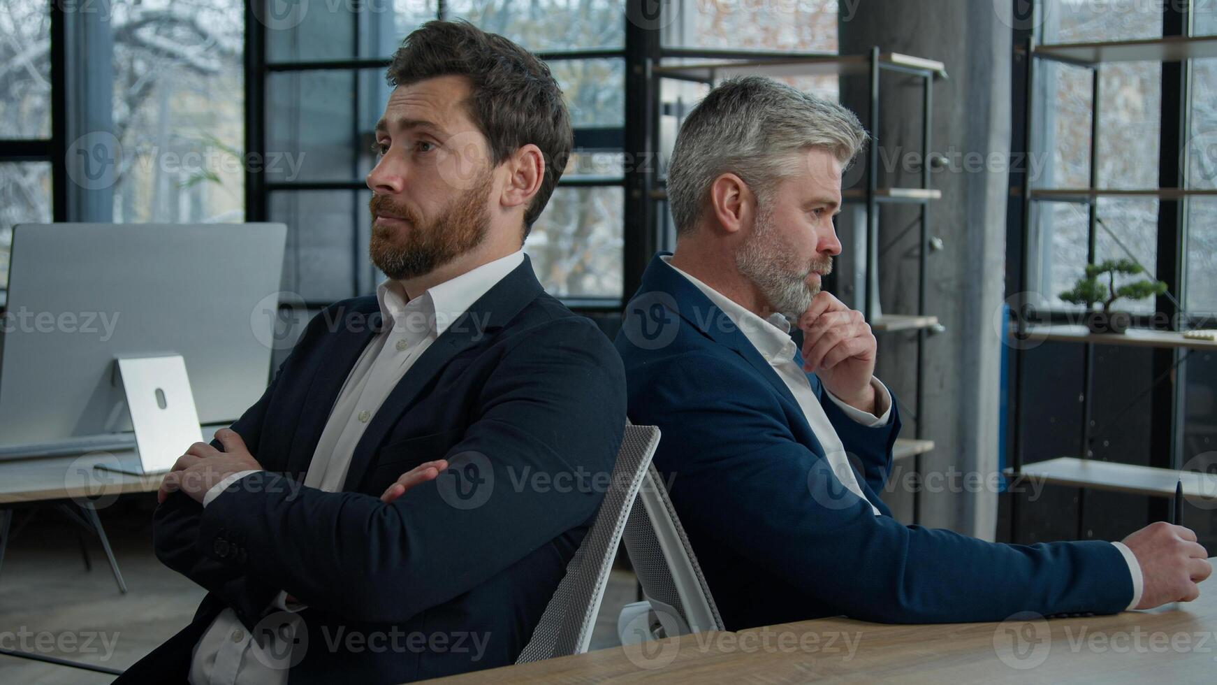 Upset shocked caucasian men businessmen partners employees sitting in office frustrated with business failure think about financial problem depressed entrepreneurs colleagues have trouble feel worried photo
