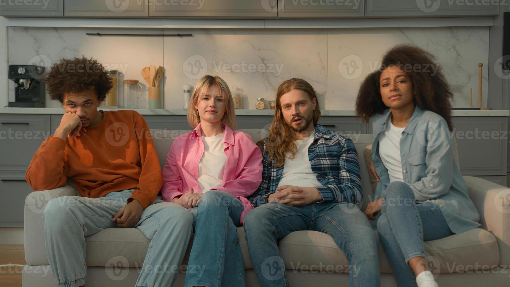 Multiracial people multiethnic friends diversity students Caucasian women female girls African American men male guys together home couch sofa watching boring TV show movie bad film bored talking yawn photo