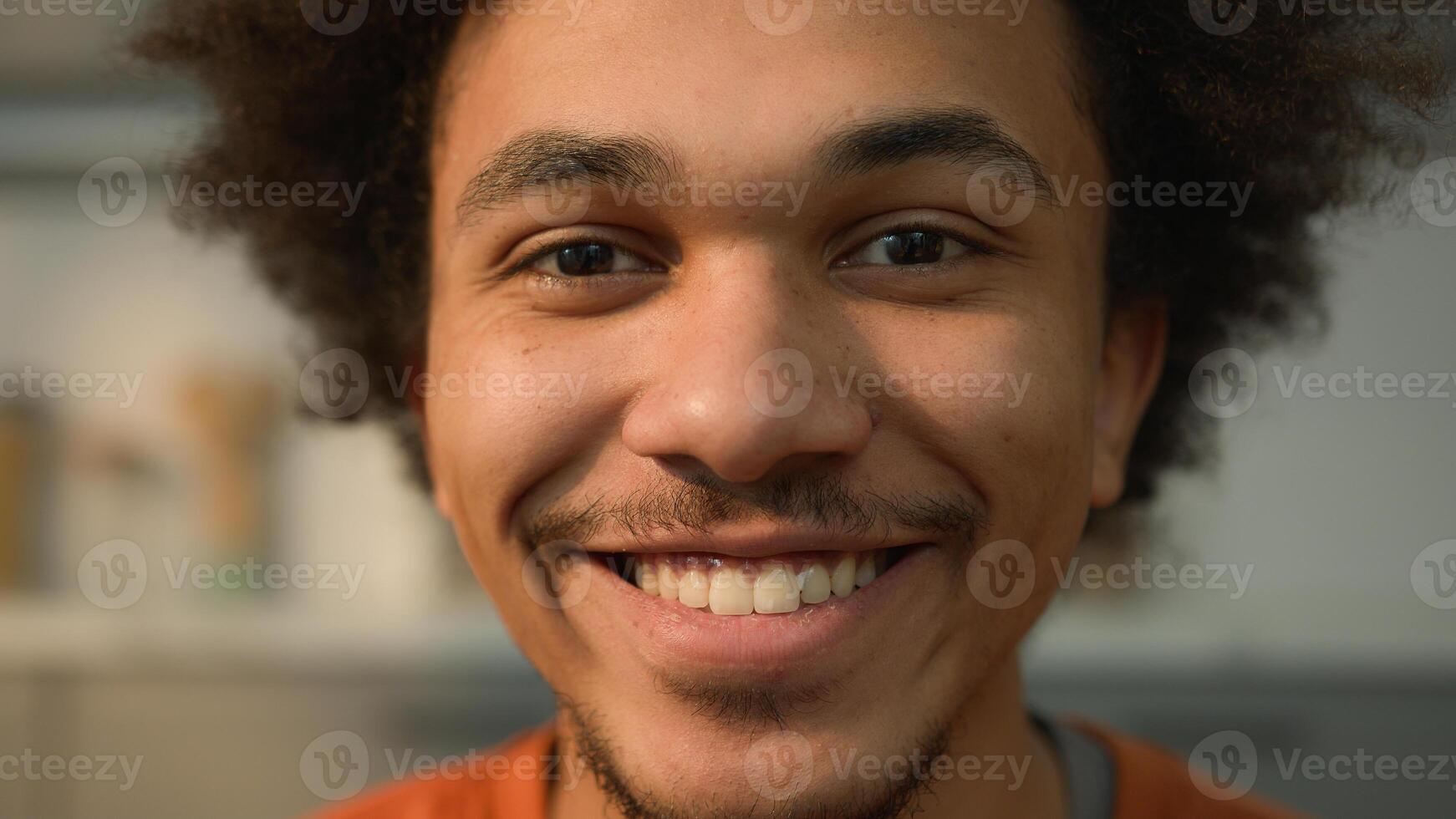 Close up portrait African American ethnic guy male man looking away to side look at camera face healthy happy smiling toothy dental teeth white skincare medicine facial laugh smile fun joy at home photo