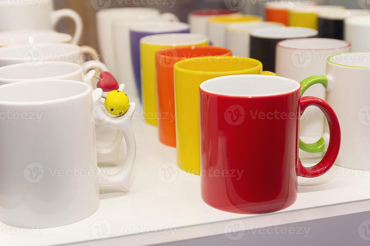 Colorful mug stall in a store closeup photo
