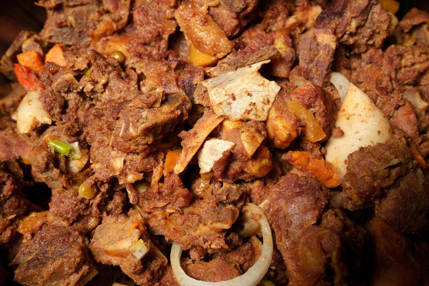a close up of a bowl of meat and onions photo