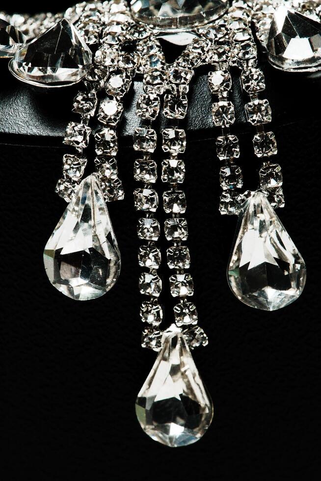a close up of a crystal necklace with a large crystal drop photo