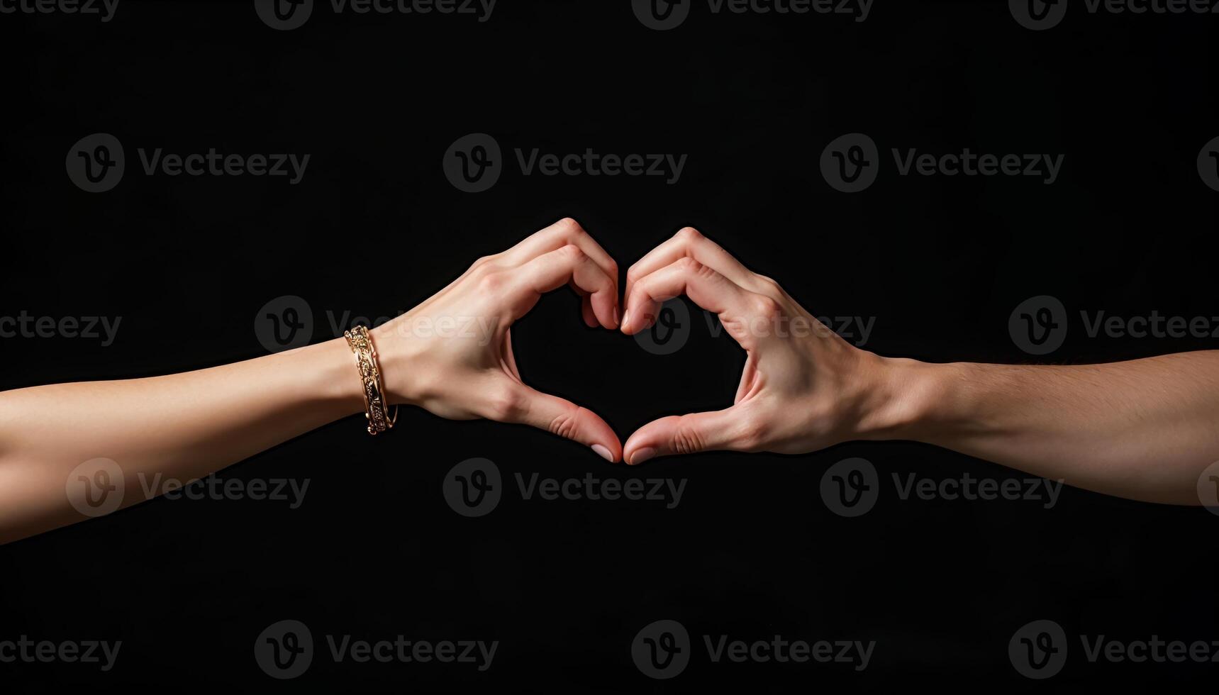Hands gesture forming heart shape on black background photo