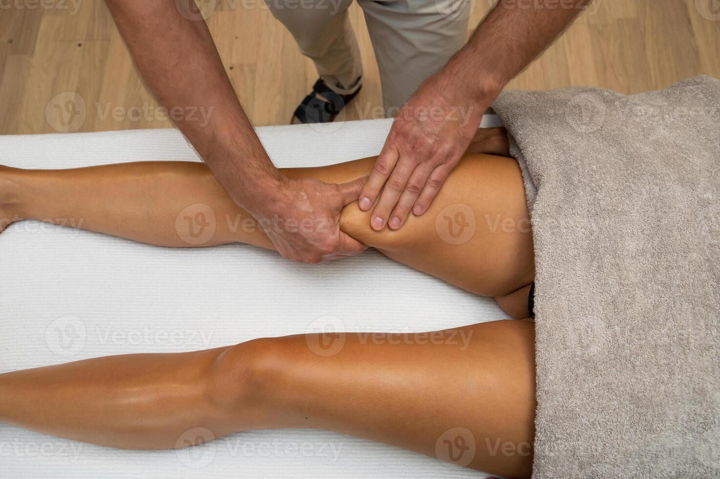 Woman getting legs massage in spa salon photo