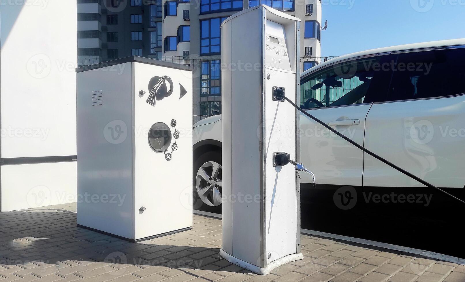 Service of stations for pumping tires of vehicles and dispensing water. Automatic pump at the gas station to check the pressure level. Inflating tires from the outside, self-service air compressor photo
