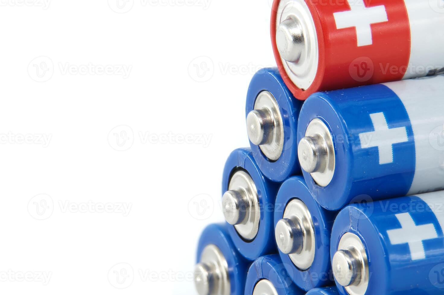 Close-up of stacked AA batteries showing the positive terminals photo