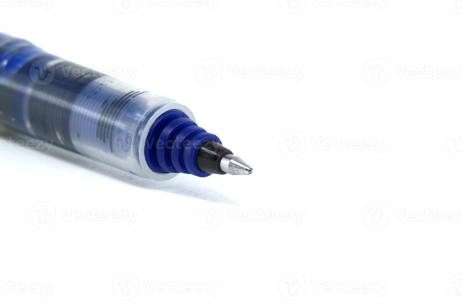 Close-up of a ballpoint pen tip on white paper for writing and office supplies photo