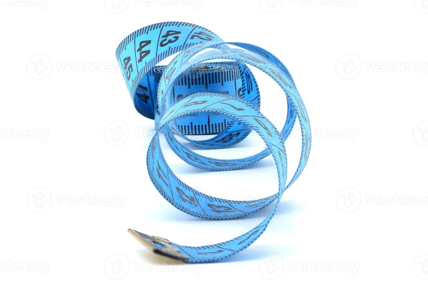 Blue measuring tape coiled on a white background representing precision, fitness, and tailoring photo