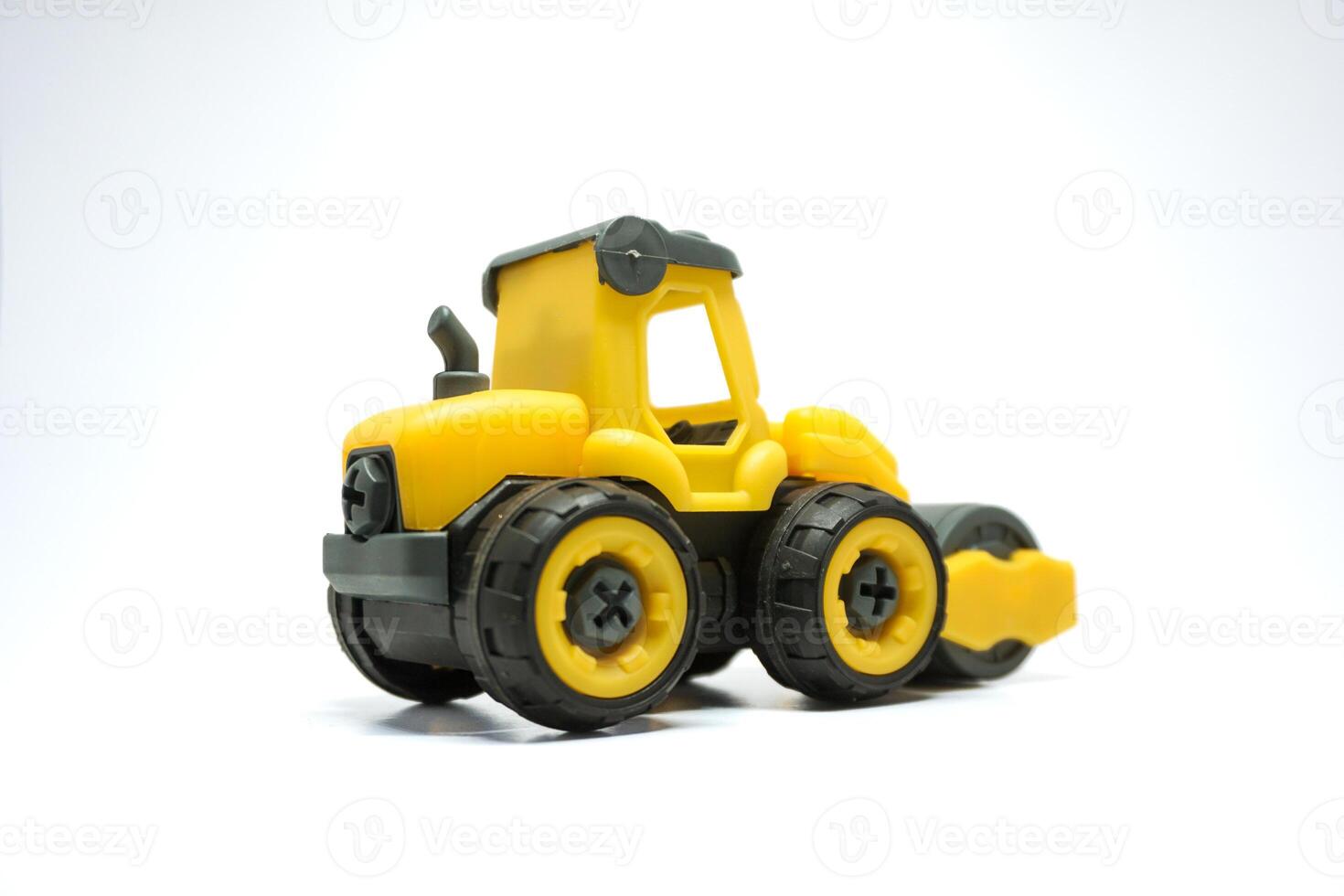 yellow tendem roller toy on white background. Tandem roller or road roller toy for kids photo