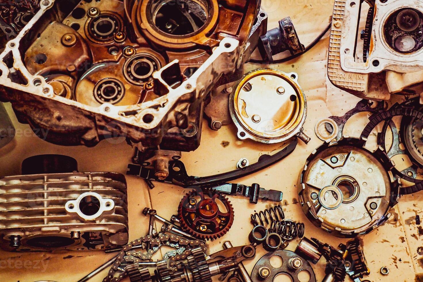 Disassembled Engine Parts on a Workbench - Mechanical Components and Tools for Repair and Maintenance photo