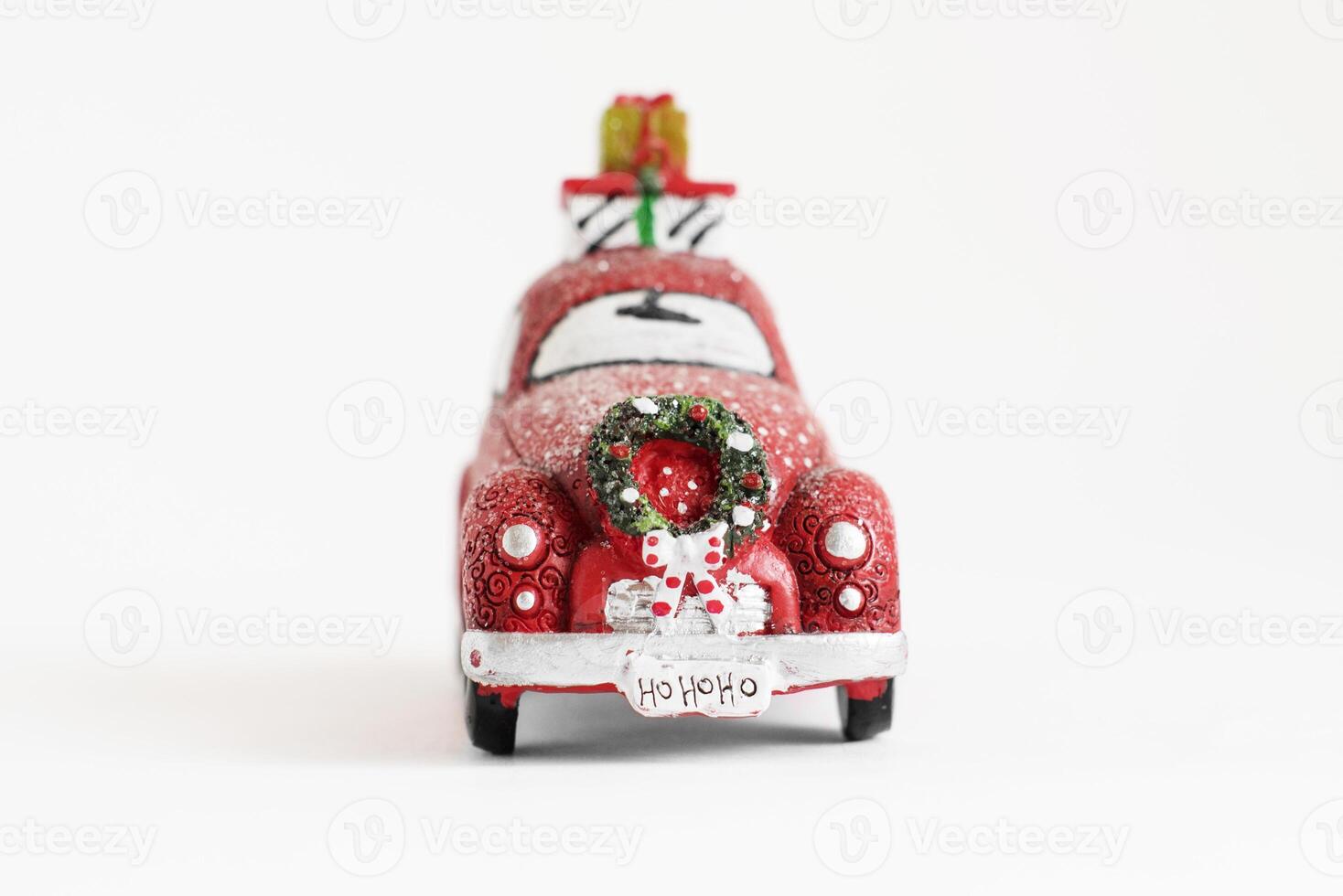 Christmas isolated red car with a wreath and gifts on a white background. photo