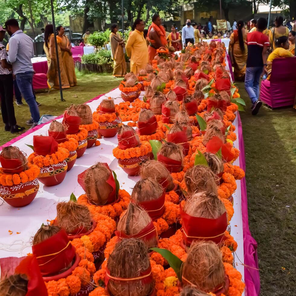 New Delhi, India July 25 2024 - Women with Kalash on head during Jagannath Temple Mangal Kalash Yatra, Indian Hindu devotees carry earthen pots containing sacred water with a coconut on top photo