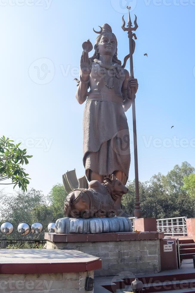 Big statue of Lord Shiv near Delhi International airport, Delhi, India, Lord Shiv big statue touching sky at main highway Mahipalpur, Delhi photo