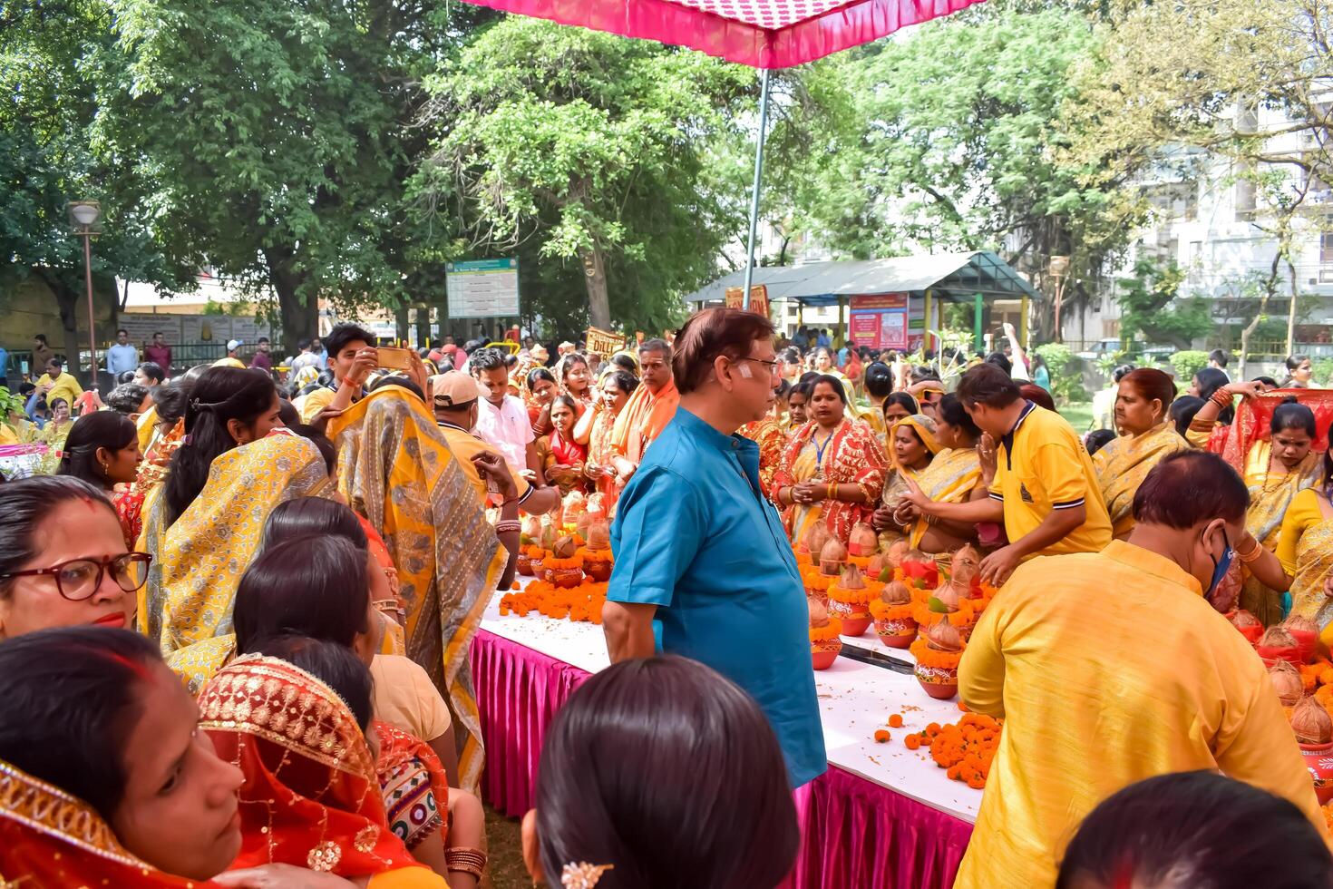 New Delhi, India July 25 2024 - Women with Kalash on head during Jagannath Temple Mangal Kalash Yatra, Indian Hindu devotees carry earthen pots containing sacred water with a coconut on top photo