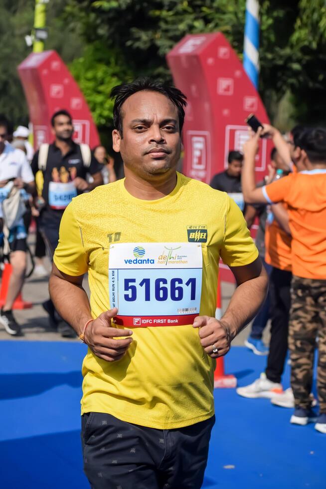 New Delhi, India - July 15 2024 - Vedanta Delhi Half Marathon race after covid in which marathon participants about to cross the finish line, Delhi Half Marathon 2023 photo