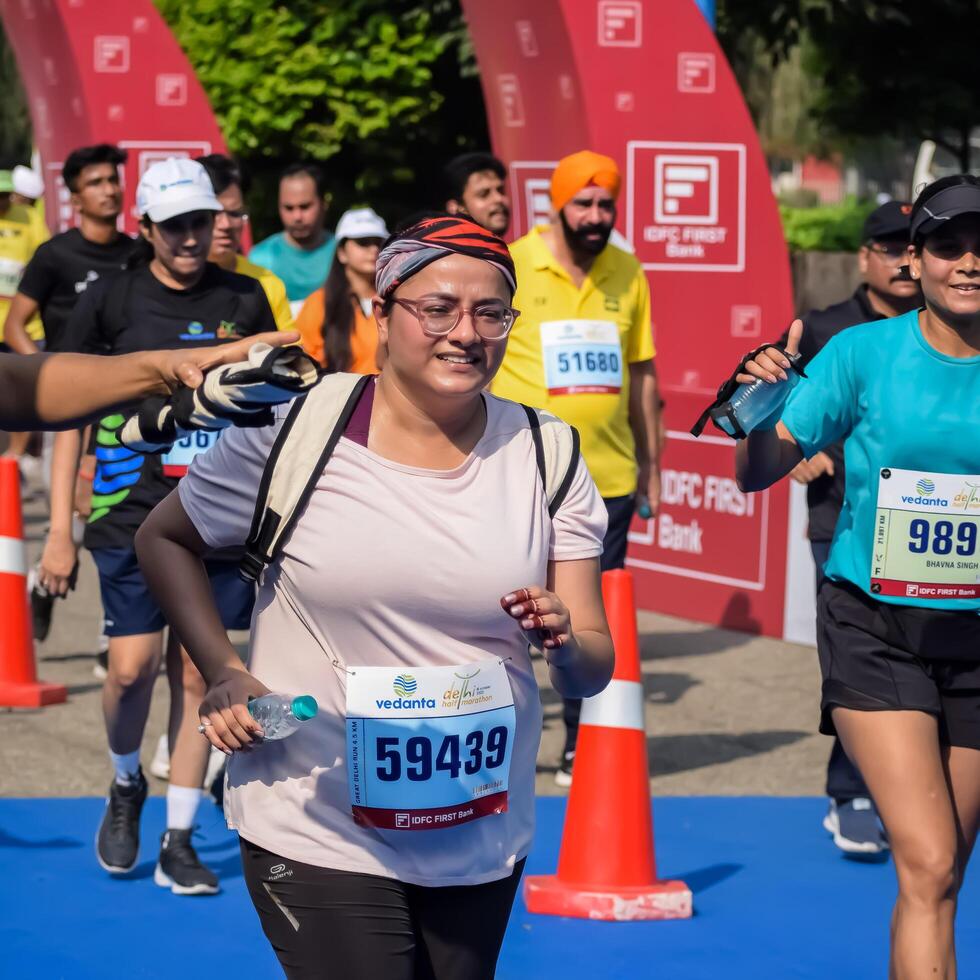 New Delhi, India - July 15 2024 - Vedanta Delhi Half Marathon race after covid in which marathon participants about to cross the finish line, Delhi Half Marathon 2023 photo