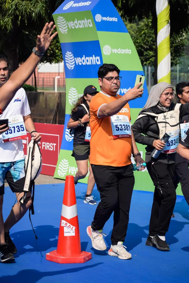 New Delhi, India - July 15 2024 - Vedanta Delhi Half Marathon race after covid in which marathon participants about to cross the finish line, Delhi Half Marathon 2023 photo