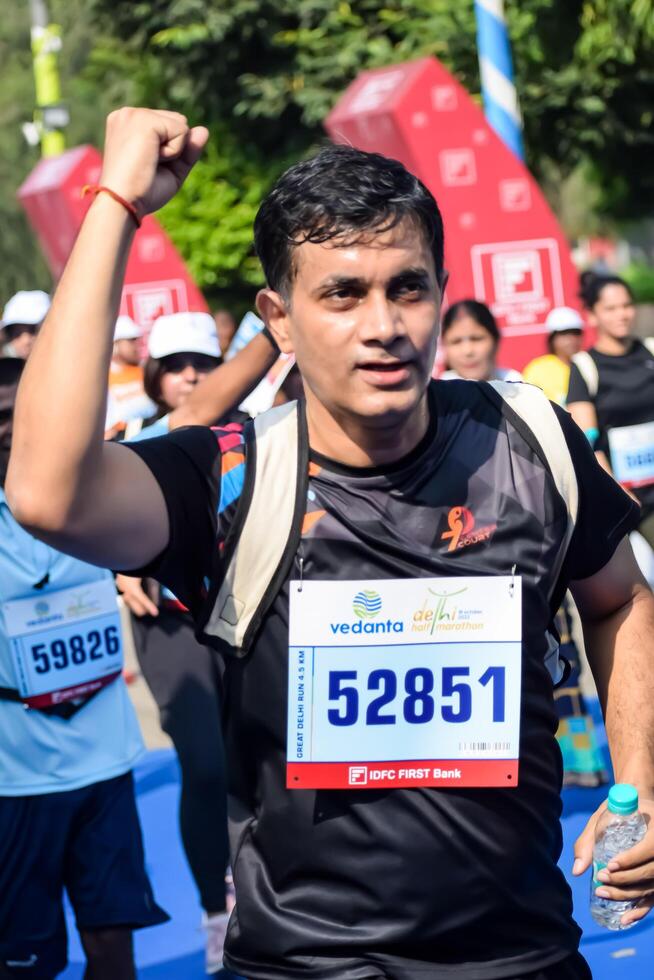 New Delhi, India - July 15 2024 - Vedanta Delhi Half Marathon race after covid in which marathon participants about to cross the finish line, Delhi Half Marathon 2023 photo