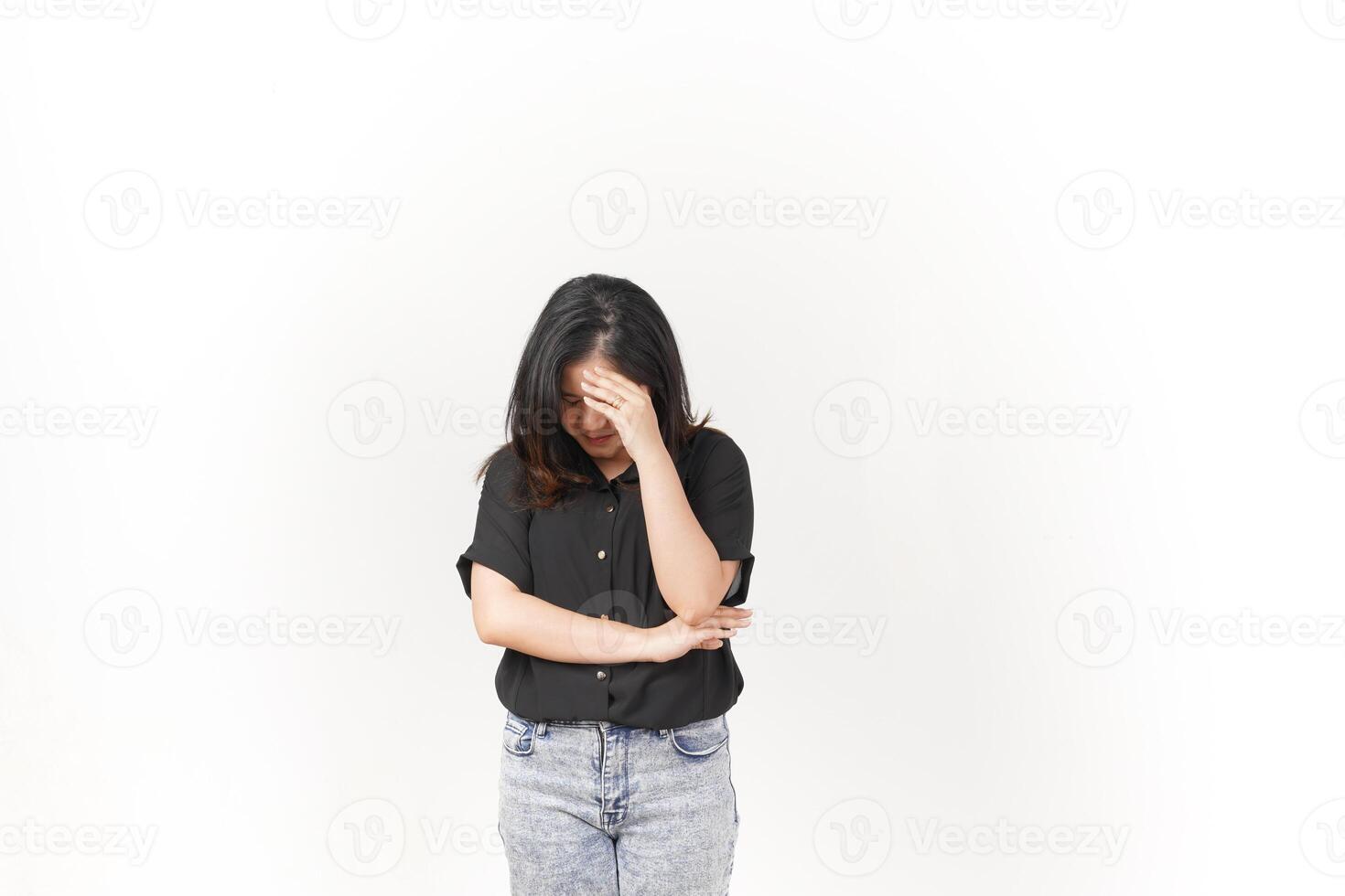 Young Asian woman suffering headache, hand on head wearing Black t-shirt and jeans isolated on white background photo