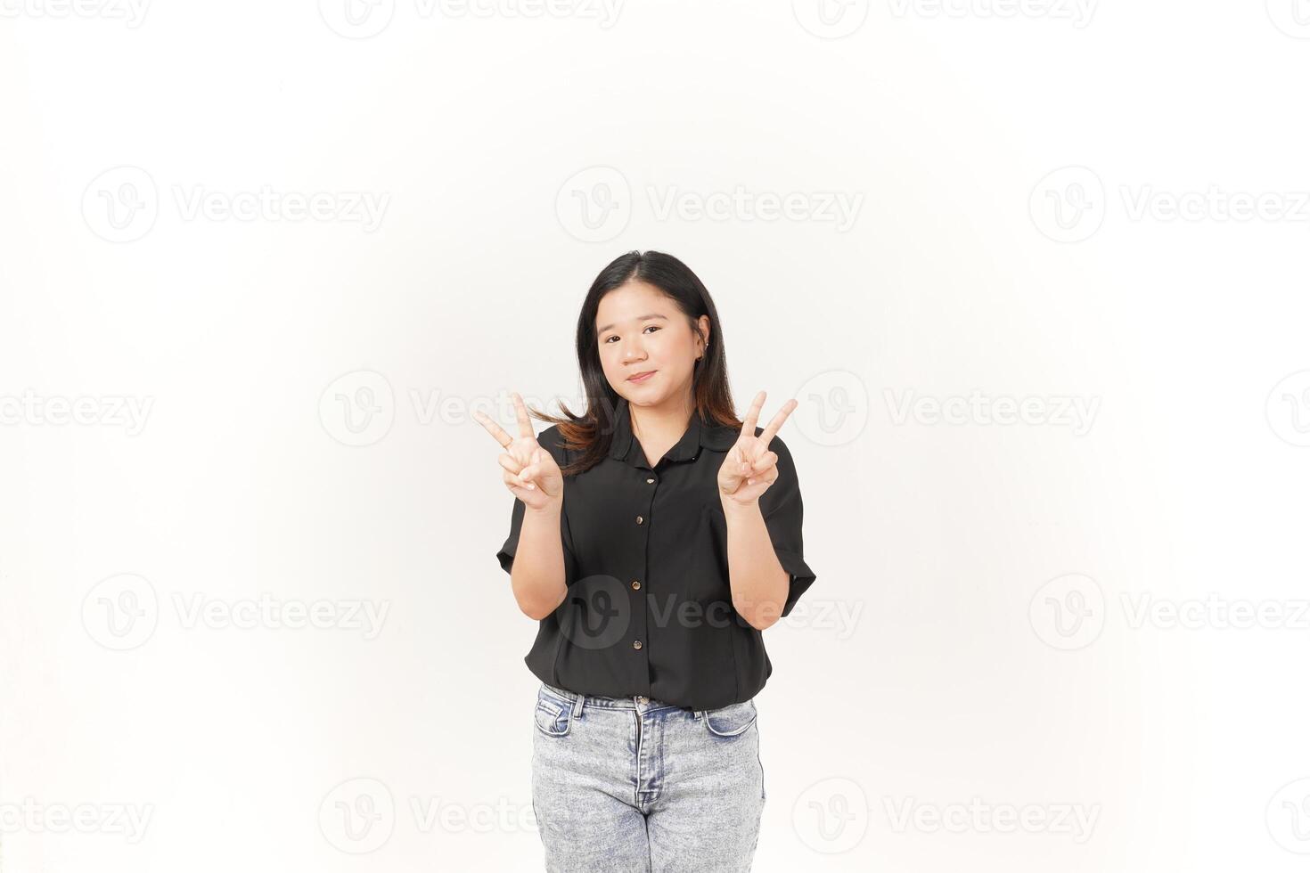 Young Asian woman showing peace sign two finger wearing Black t-shirt and jeans isolated on white background photo