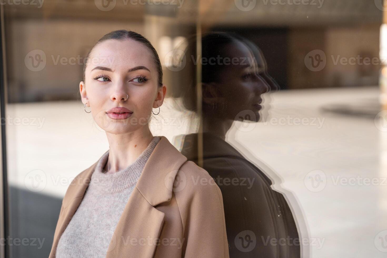 Young beautiful woman wearing coat walking in the city centre of Prague, Czech republic, Europe photo