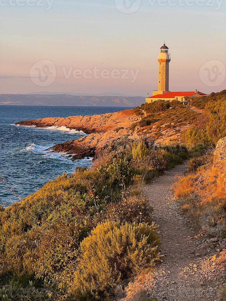 Lighthouse Stoncica at sunset light on island Vis, Croatia. photo