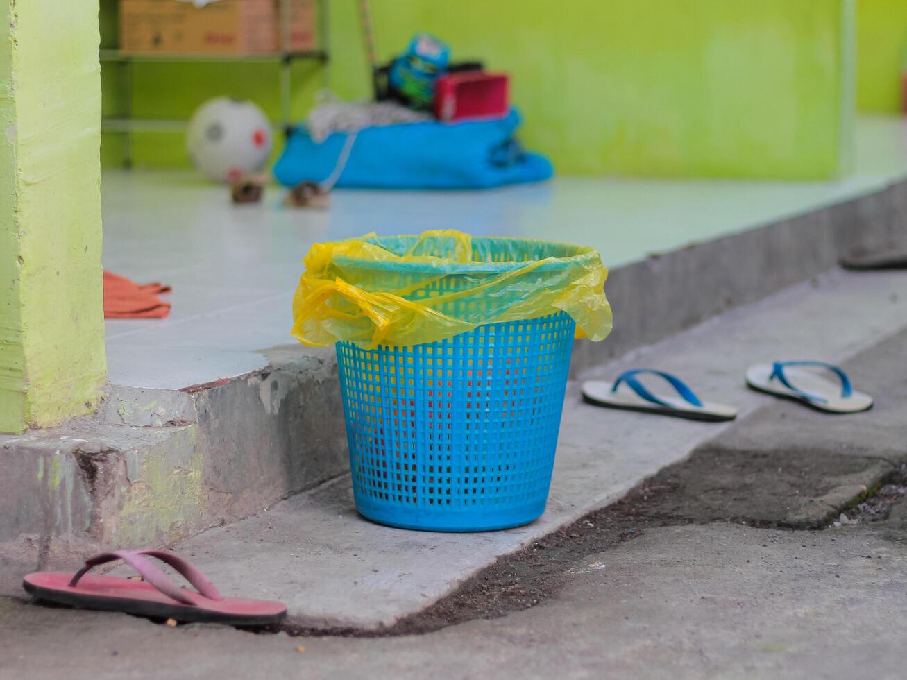 Plastic trash can in front of the room photo