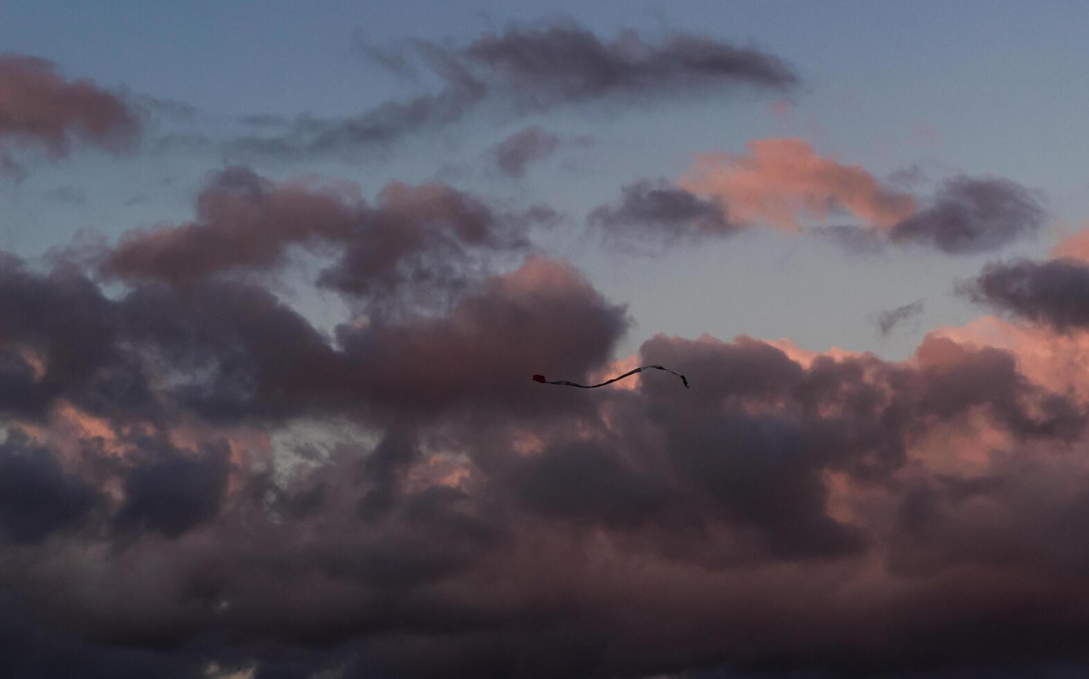 Dramatic clouds in the blue sky in the morning, the rising sun rays hitting the clouds photo