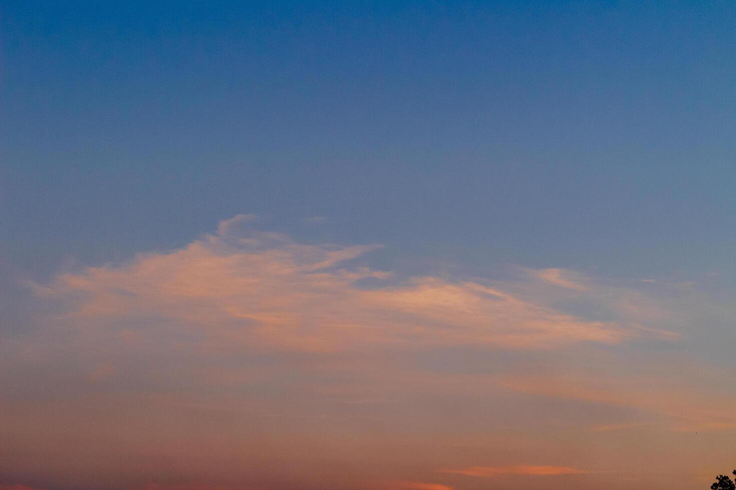 Dramatic clouds in the blue sky in the morning, the rising sun rays hitting the clouds photo