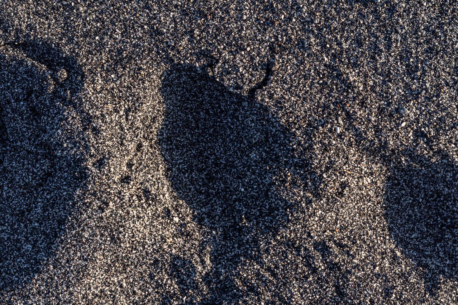 black sand texture on the beach photo