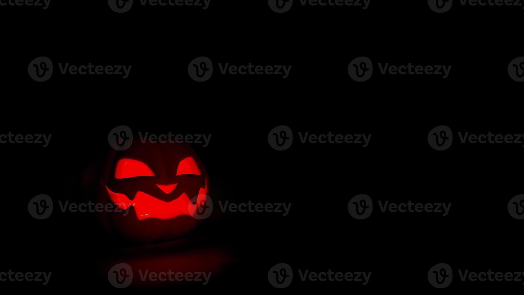 Halloween pumpkin glowing on black background. Jack o lantern Halloween background. 3D rendering photo