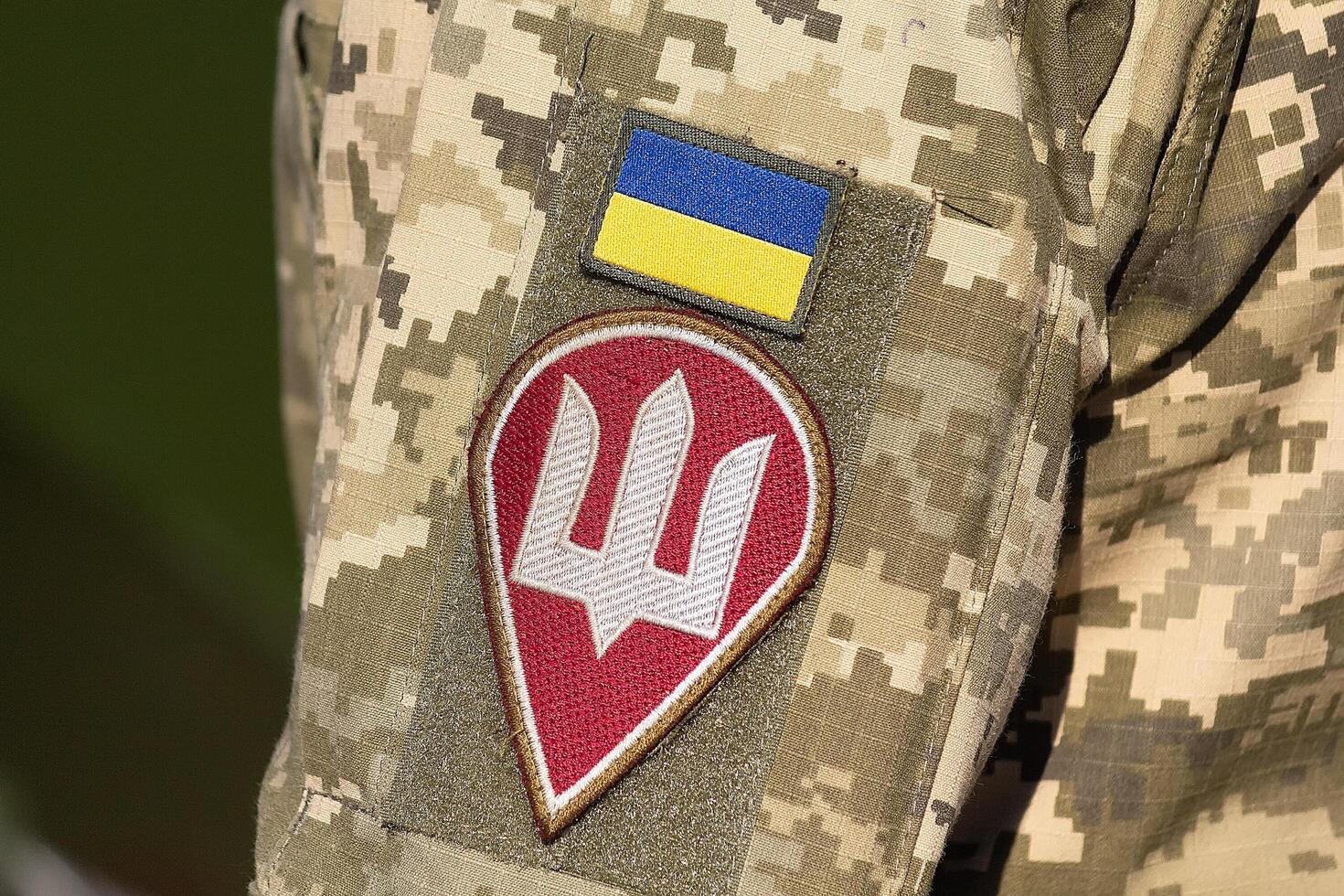 Coat of arms and flag on the chevrons of a Ukrainian soldier photo