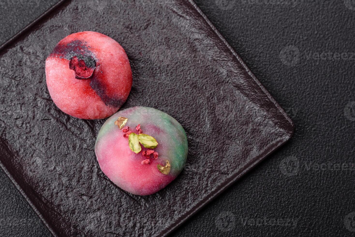 Delicious cold Japanese mochi dessert with colorful rice dough shell and fruit filling photo