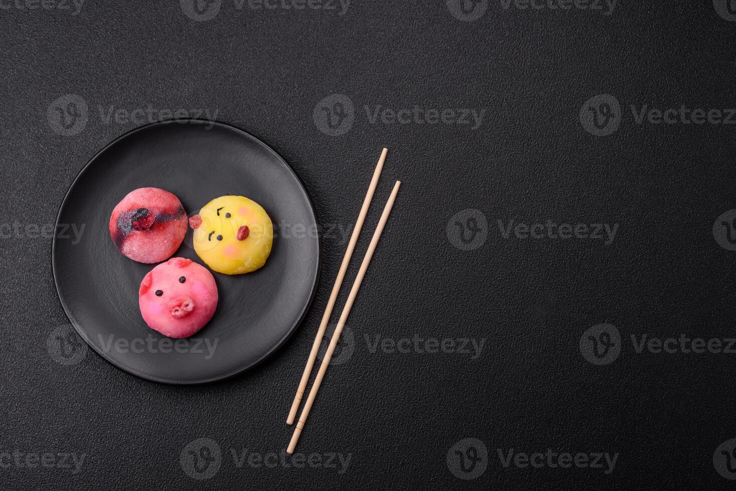Delicious cold Japanese mochi dessert with colorful rice dough shell and fruit filling photo