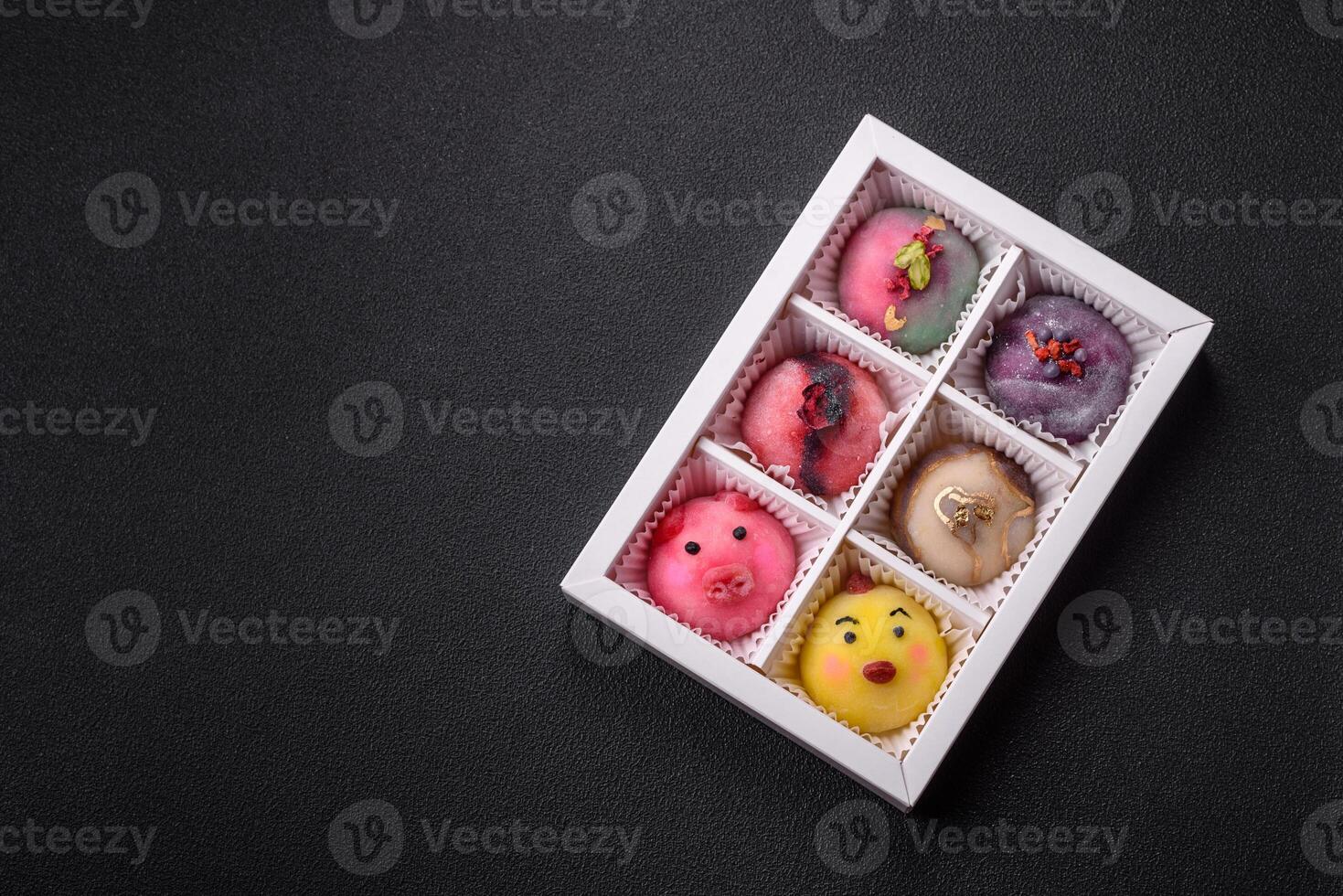 Delicious cold Japanese mochi dessert with colorful rice dough shell and fruit filling photo