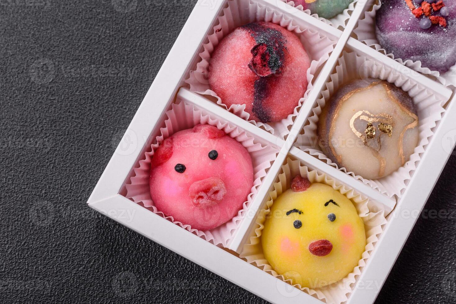 Delicious cold Japanese mochi dessert with colorful rice dough shell and fruit filling photo