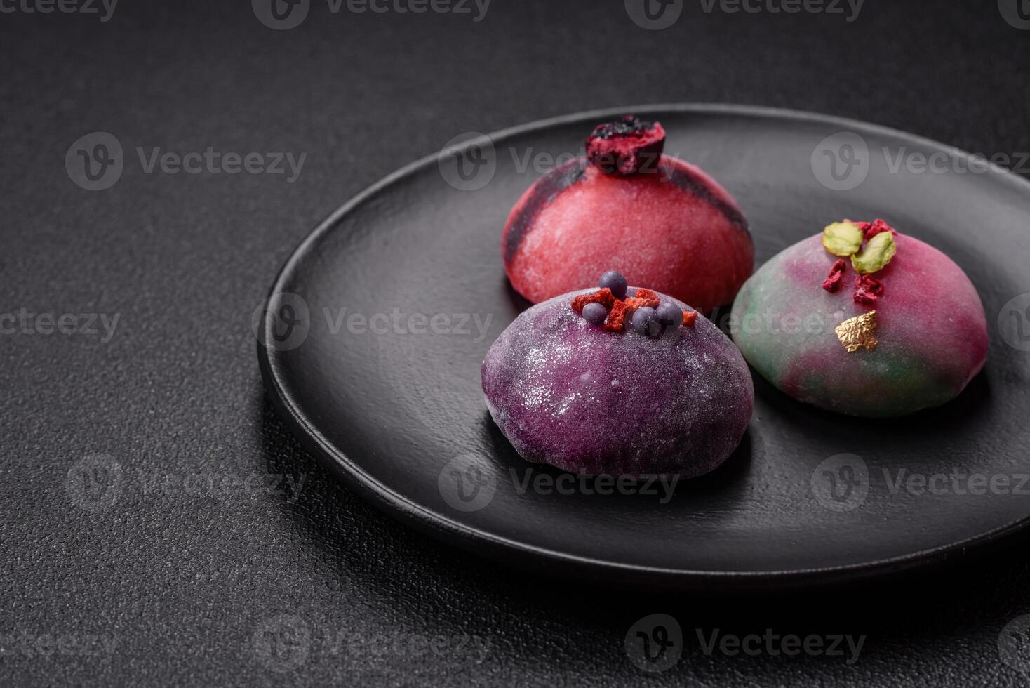 Delicious cold Japanese mochi dessert with colorful rice dough shell and fruit filling photo