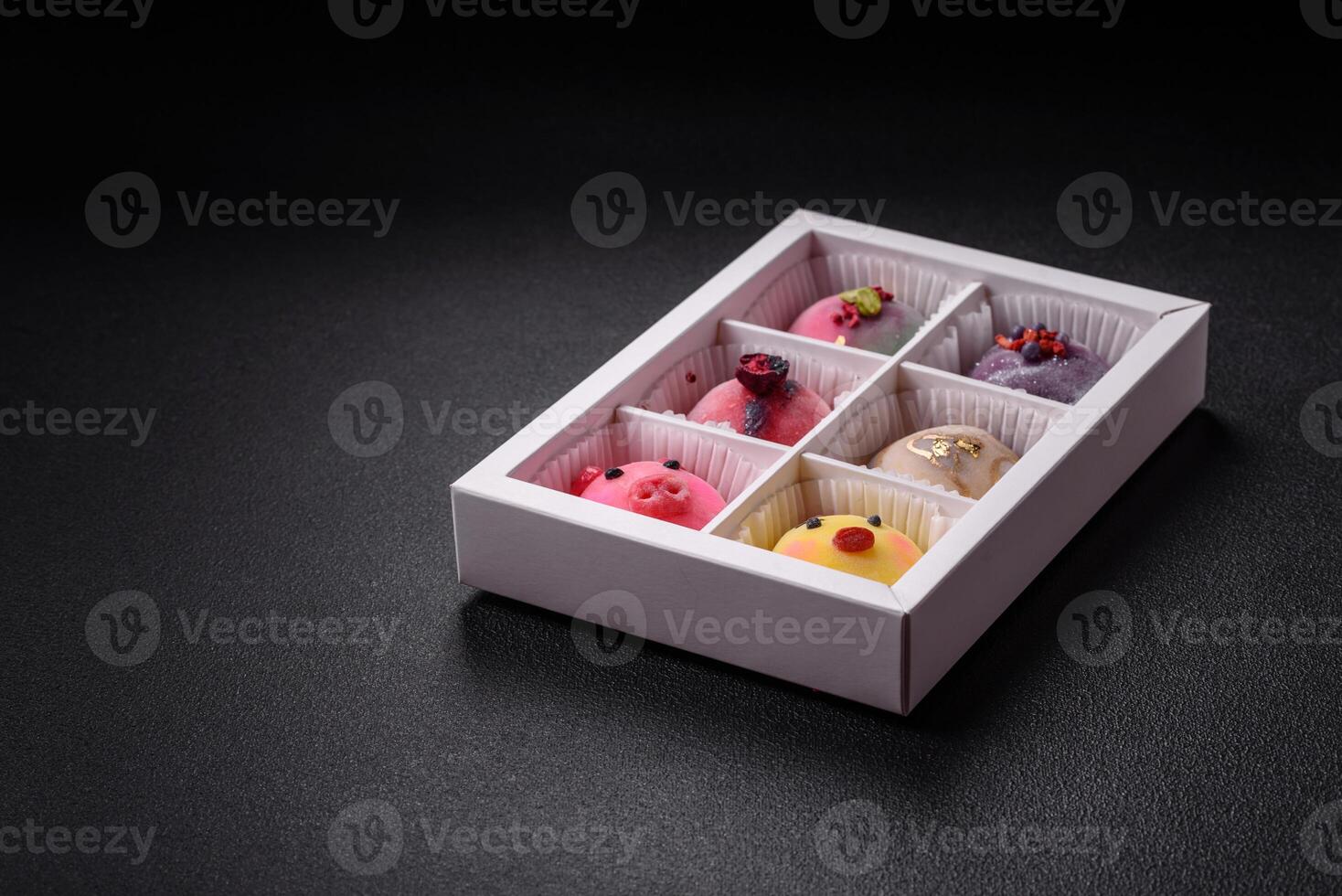 Delicious cold Japanese mochi dessert with colorful rice dough shell and fruit filling photo