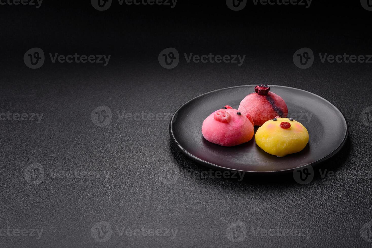 Delicious cold Japanese mochi dessert with colorful rice dough shell and fruit filling photo