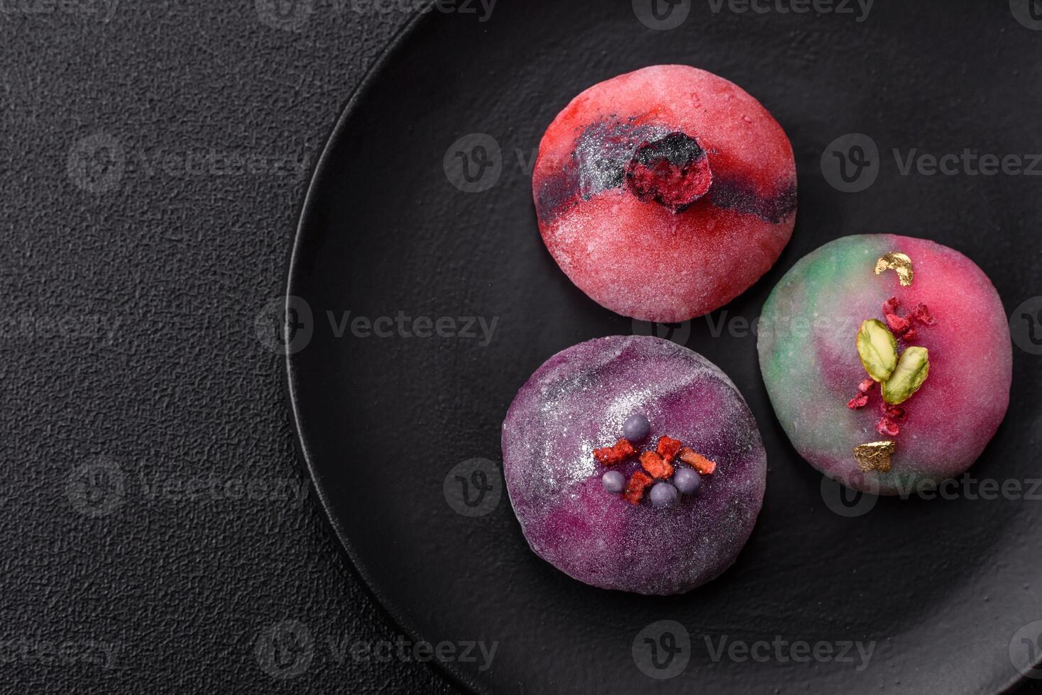 Delicious cold Japanese mochi dessert with colorful rice dough shell and fruit filling photo