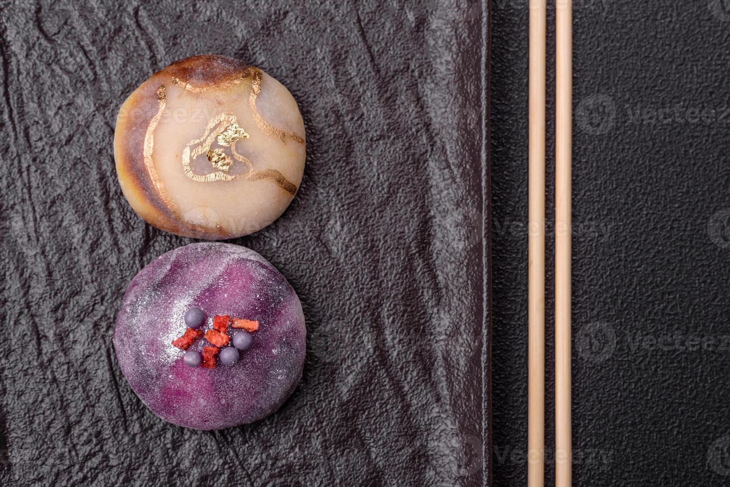 Delicious cold Japanese mochi dessert with colorful rice dough shell and fruit filling photo