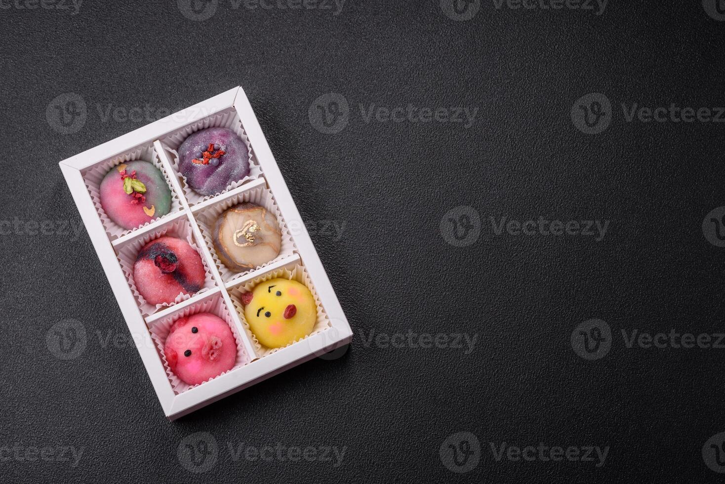 Delicious cold Japanese mochi dessert with colorful rice dough shell and fruit filling photo