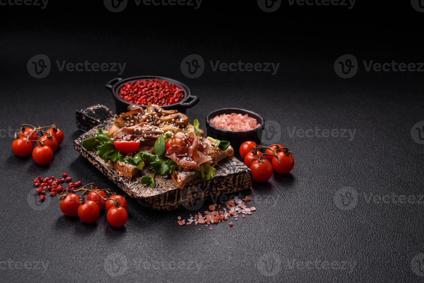 Variation of several toasts or bruschetta with prosciutto, mushrooms and veal photo