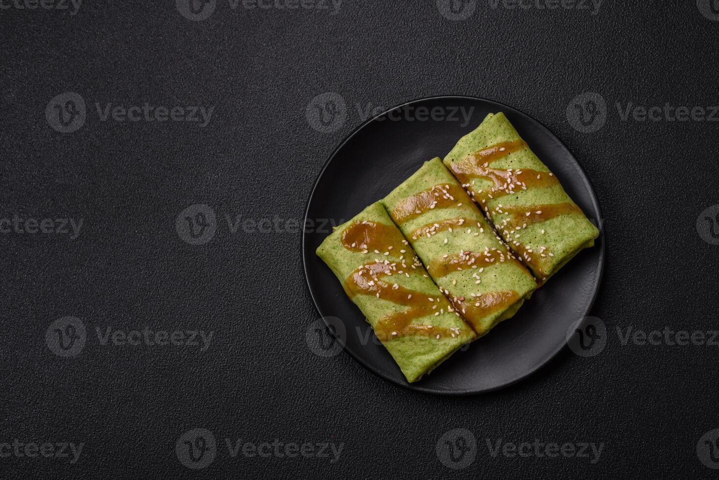 Spinach Crepes stuffed with chicken, mushrooms, salt and spices photo