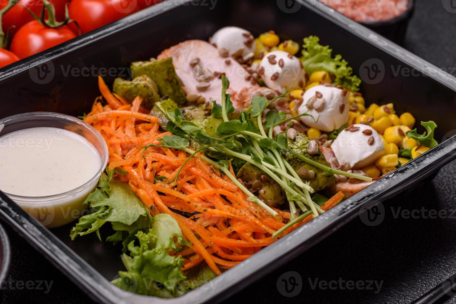Fresh juicy salad with meat, mozzarella, carrots, lettuce, corn photo