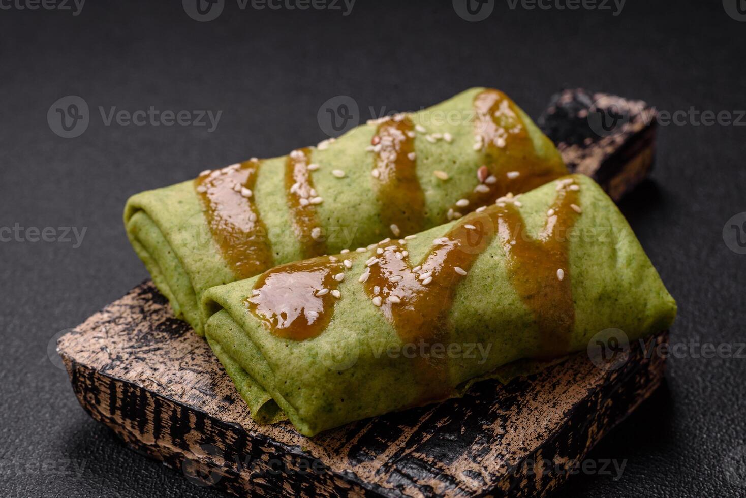 Spinach Crepes stuffed with chicken, mushrooms, salt and spices photo