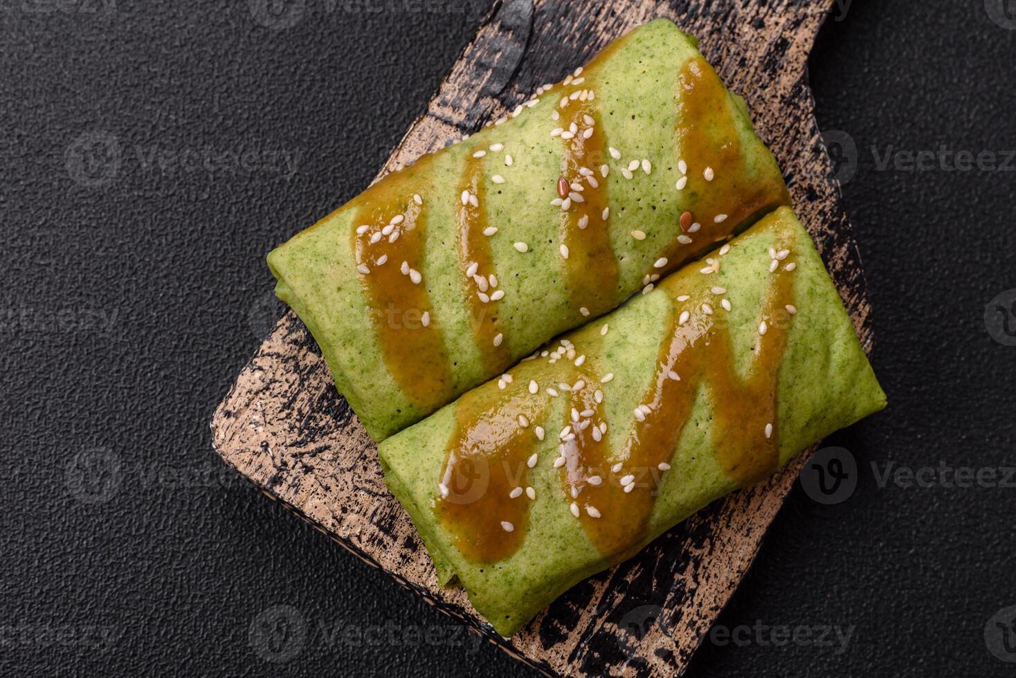 Spinach Crepes stuffed with chicken, mushrooms, salt and spices photo