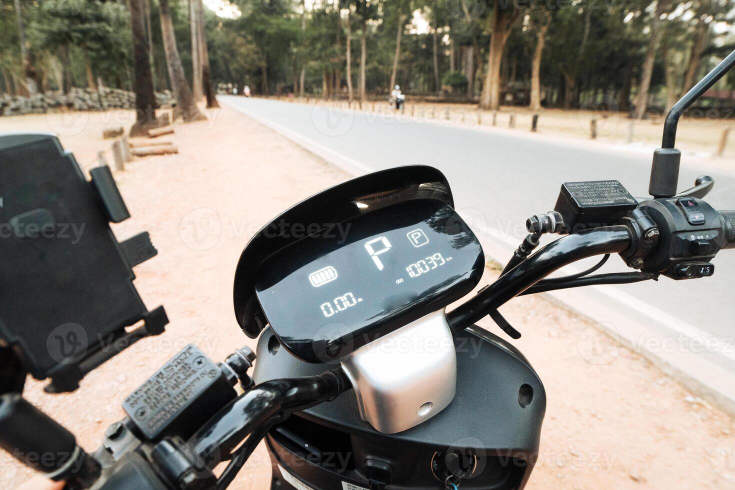 Close up electric motorbike scooter display on with parking sign and parameters displayed photo