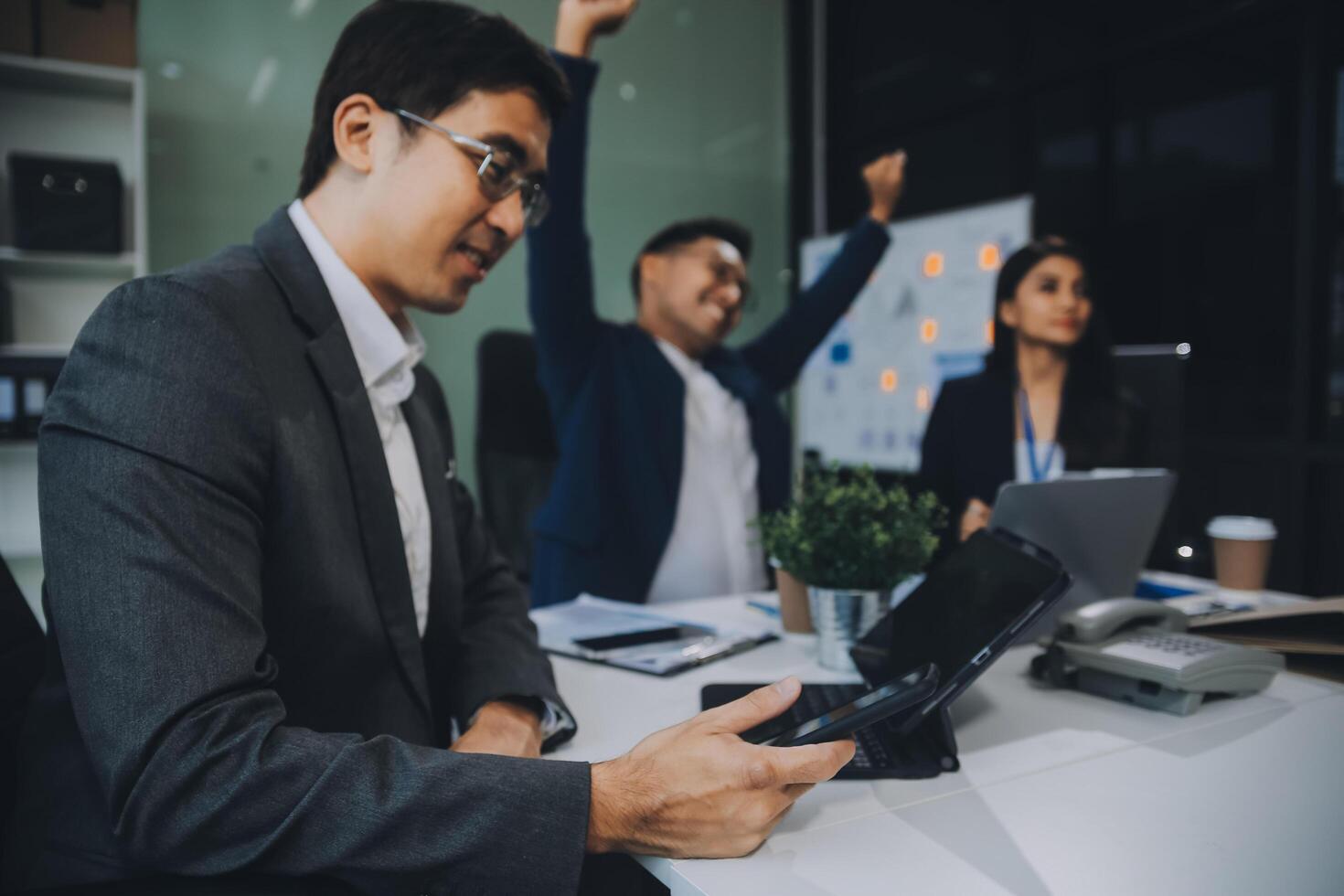 Group of colleagues engaging in a discussion during a business meeting in a conference room. Happy business people, men and women, collaborating and working towards their shared goals. photo